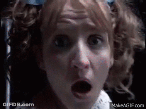 A Close Up Of A Woman 'S Face With A Surprised Look On Her Face .. GIF