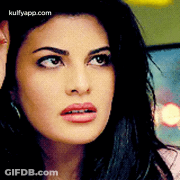 A Close Up Of A Woman 'S Face With A Surprised Look On Her Face GIF