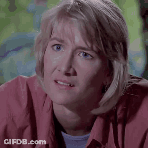 A Close Up Of A Woman 'S Face With A Surprised Look On Her Face . GIF
