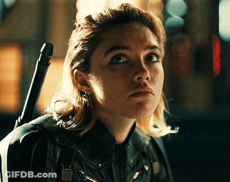 A Close Up Of A Woman 'S Face With A Sword On Her Shoulder GIF