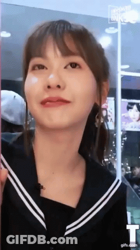 A Close Up Of A Woman 'S Face With A T On The Bottom Right GIF