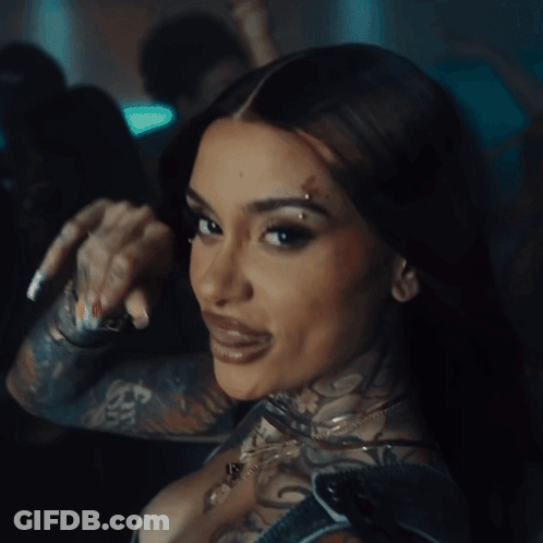 A Close Up Of A Woman 'S Face With A Tattoo On Her Face GIF