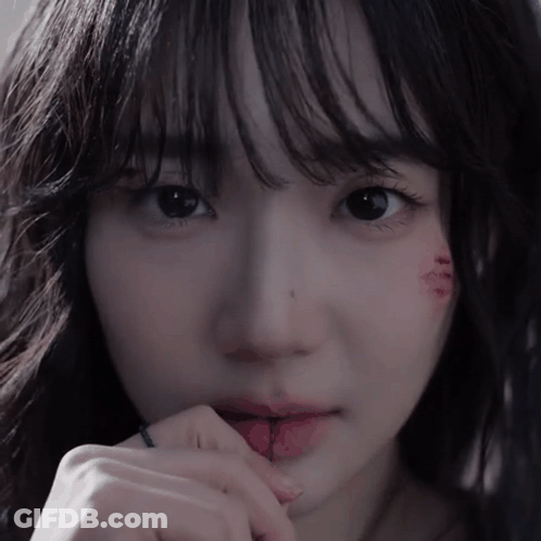 A Close Up Of A Woman 'S Face With A Tattoo On Her Face GIF