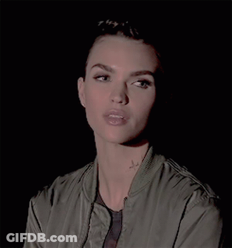 A Close Up Of A Woman 'S Face With A Tattoo On Her Neck GIF