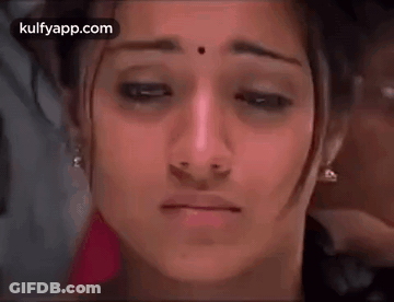 A Close Up Of A Woman 'S Face With A Tear Coming Out Of Her Eye . GIF