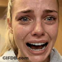 A Close Up Of A Woman 'S Face With A Tear Coming Out Of Her Eye GIF