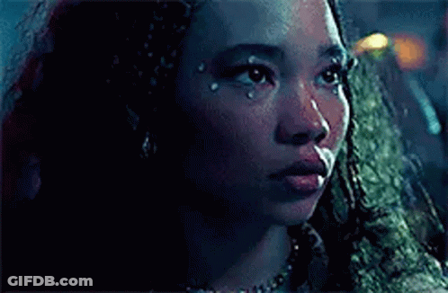 A Close Up Of A Woman 'S Face With A Tear Coming Out Of Her Eye . GIF