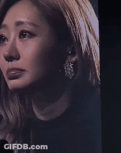 A Close Up Of A Woman 'S Face With A Tear Coming Out Of Her Eye GIF