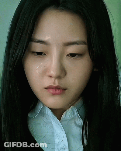 A Close Up Of A Woman 'S Face With A Tear Coming Out Of Her Eye GIF