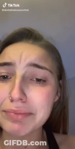 A Close Up Of A Woman 'S Face With A Tear Coming Out Of Her Eyes . GIF