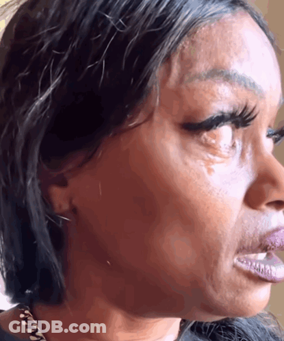 A Close Up Of A Woman 'S Face With A Tear In Her Eye GIF