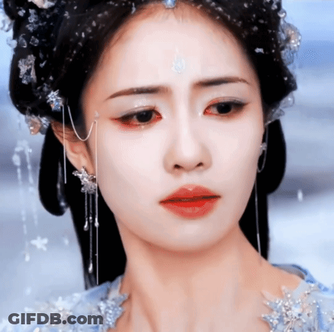 A Close Up Of A Woman 'S Face With A Tear Running Down Her Cheek GIF