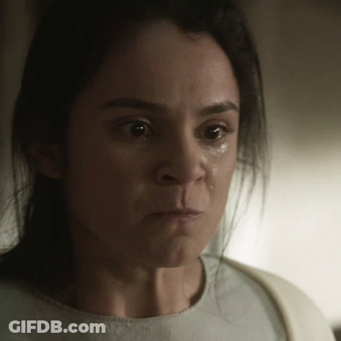 A Close Up Of A Woman 'S Face With A Tear Running Down Her Cheek GIF