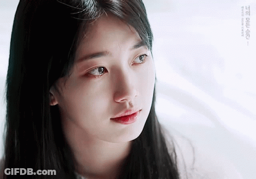 A Close Up Of A Woman 'S Face With A Tear Running Down Her Cheek GIF