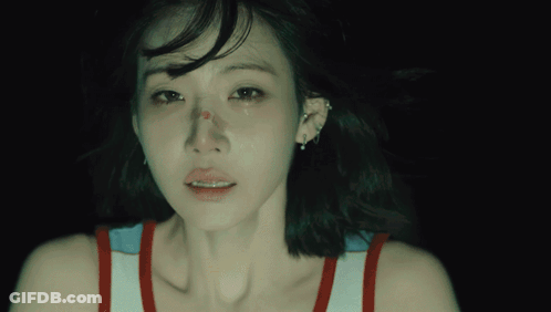 A Close Up Of A Woman 'S Face With A Tear Running Down Her Cheek GIF