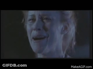 A Close Up Of A Woman 'S Face With A Tear Running Down Her Cheek . GIF