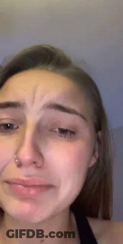 A Close Up Of A Woman 'S Face With A Tear Running Down Her Face . GIF