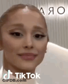 A Close Up Of A Woman 'S Face With A Tik Tok Sticker On It . GIF