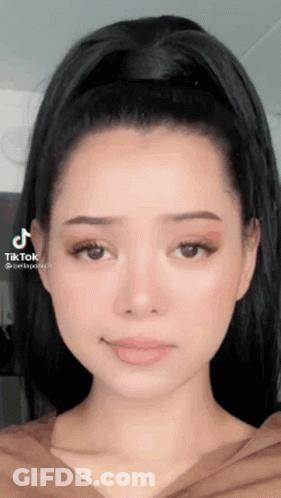 A Close Up Of A Woman 'S Face With A Tiktok Watermark GIF