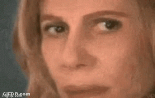A Close Up Of A Woman 'S Face With A Triangle On Her Forehead And A Mathematical Equation . GIF