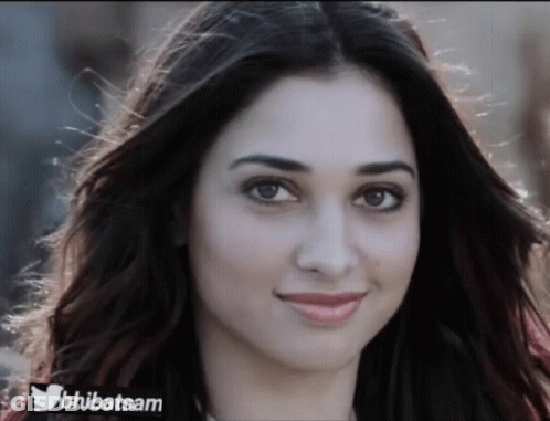 A Close Up Of A Woman 'S Face With A Twitter Logo On The Bottom Right GIF