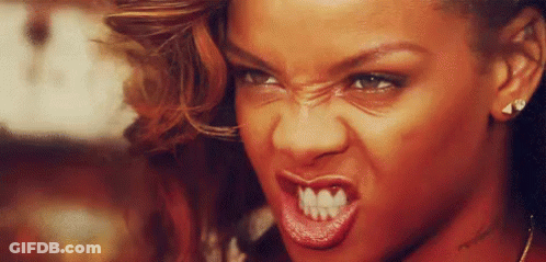 A Close Up Of A Woman 'S Face With A Very Angry Expression . GIF