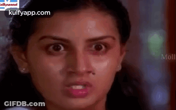 A Close Up Of A Woman 'S Face With A Very Angry Look On Her Face . GIF