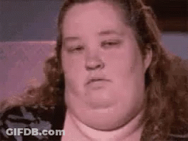 A Close Up Of A Woman 'S Face With A Very Large Neck . GIF
