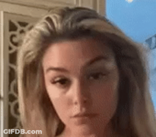 A Close Up Of A Woman 'S Face With A Very Serious Look On Her Face . GIF