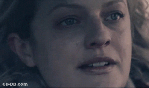 A Close Up Of A Woman 'S Face With A Very Serious Look On Her Face GIF