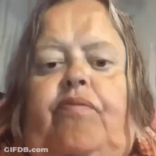 A Close Up Of A Woman 'S Face With A Very Serious Look On Her Face . GIF