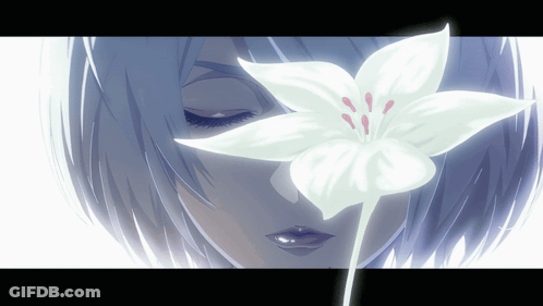 A Close Up Of A Woman 'S Face With A White Flower In Front Of Her Eyes GIF