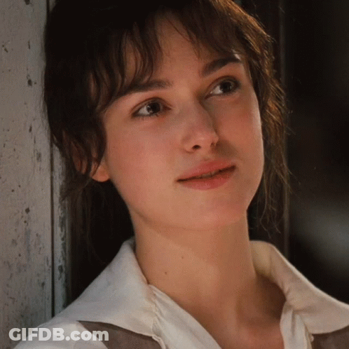 A Close Up Of A Woman 'S Face With A White Shirt GIF