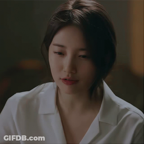 A Close Up Of A Woman 'S Face With A White Shirt GIF