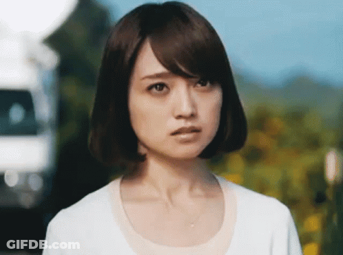 A Close Up Of A Woman 'S Face With A White Shirt On GIF