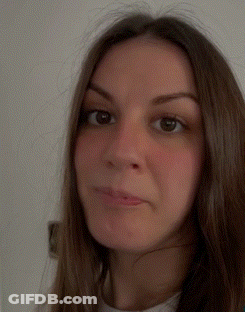A Close Up Of A Woman 'S Face With A White Shirt On GIF