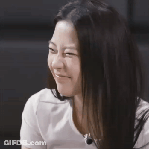 A Close Up Of A Woman 'S Face With A White Shirt On GIF