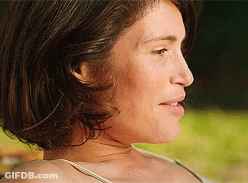 A Close Up Of A Woman 'S Face With A White Shirt On GIF
