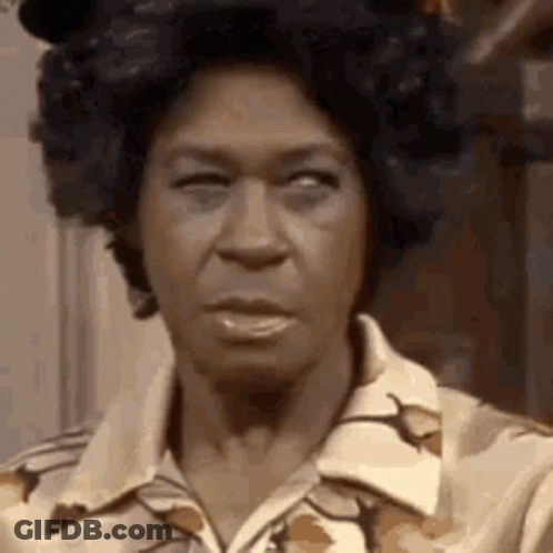 A Close Up Of A Woman 'S Face With A Wig On . GIF