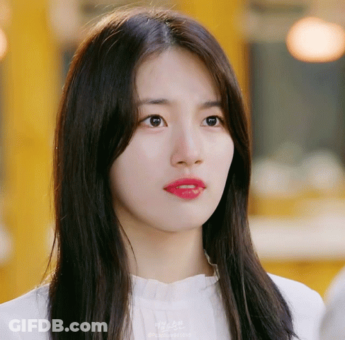 A Close Up Of A Woman 'S Face With A Yellow Background And A Watermark That Says ' Korean ' On It GIF