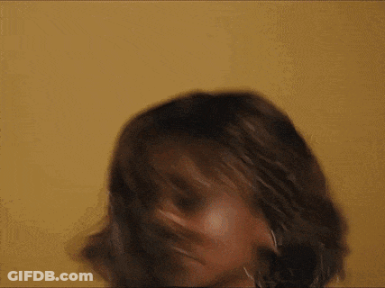 A Close Up Of A Woman 'S Face With A Yellow Background . GIF