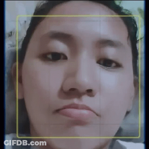A Close Up Of A Woman 'S Face With A Yellow Border Around Her Face . GIF