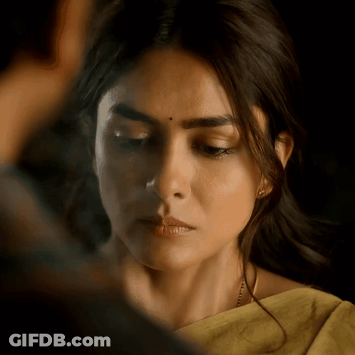 A Close Up Of A Woman 'S Face With A Yellow Saree On GIF