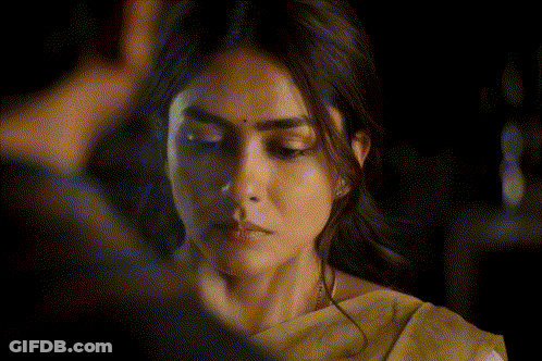 A Close Up Of A Woman 'S Face With A Yellow Saree GIF