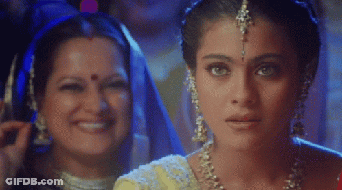 A Close Up Of A Woman 'S Face With Another Woman Behind Her Smiling GIF
