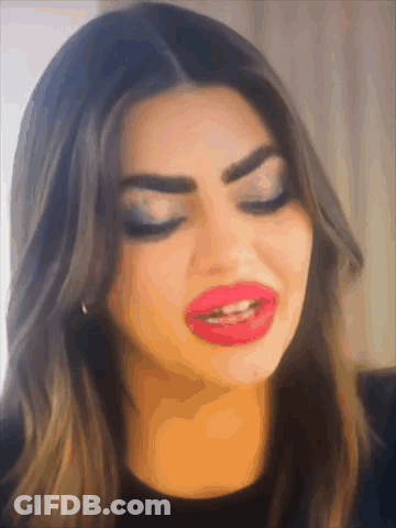 A Close Up Of A Woman 'S Face With Big Red Lips GIF