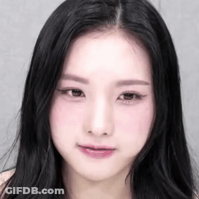 A Close Up Of A Woman 'S Face With Black Hair And Pink Lips GIF