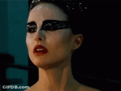 A Close Up Of A Woman 'S Face With Black Makeup And Red Lipstick . GIF