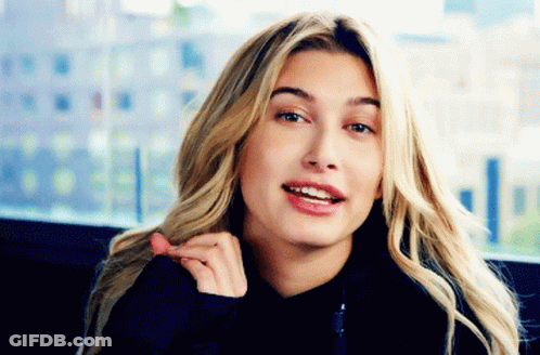 A Close Up Of A Woman 'S Face With Blonde Hair GIF