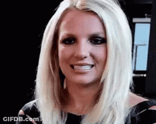 A Close Up Of A Woman 'S Face With Blonde Hair And A Black Dress . GIF